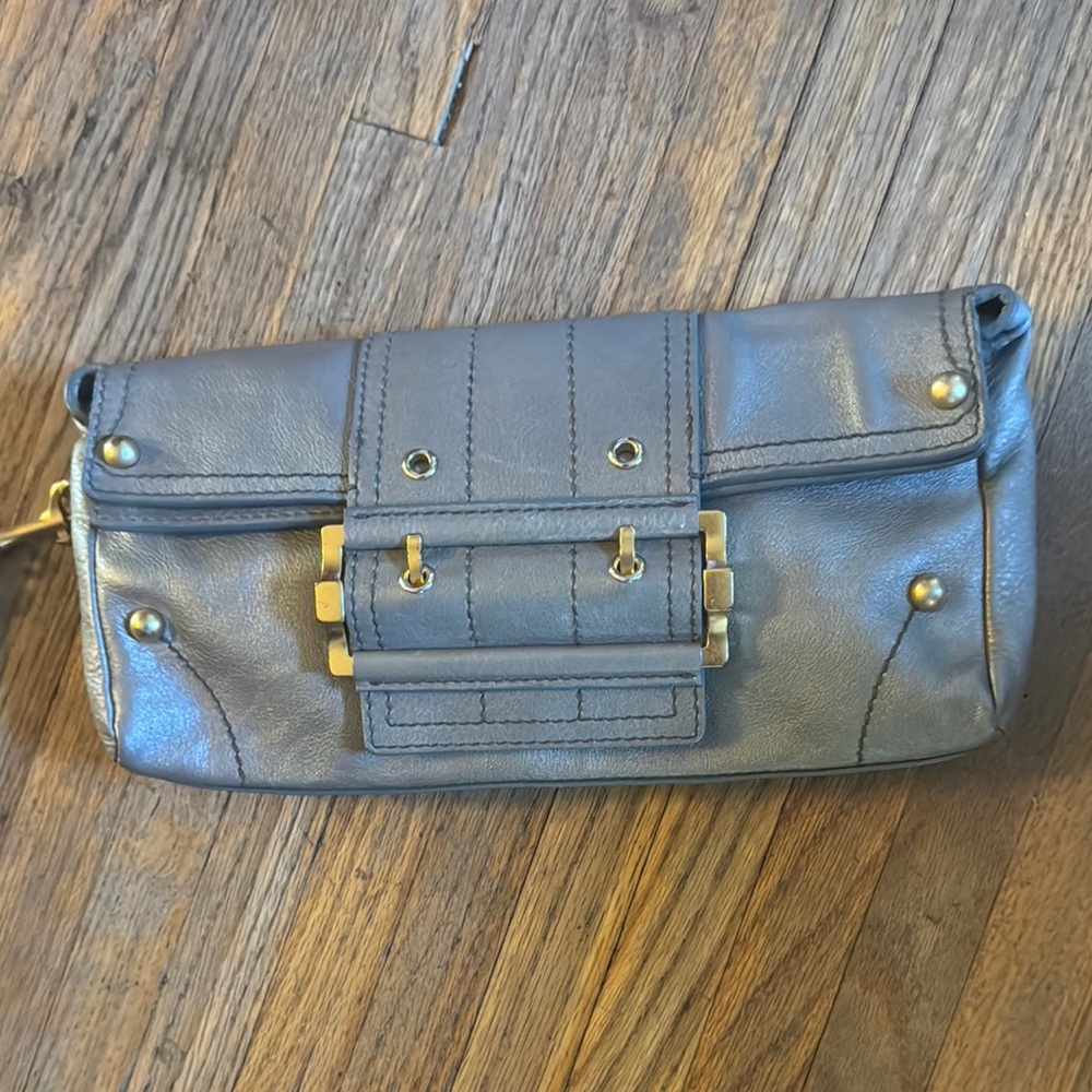 Givenchy  Stylish platinum leather Clutch with Gold Accents.